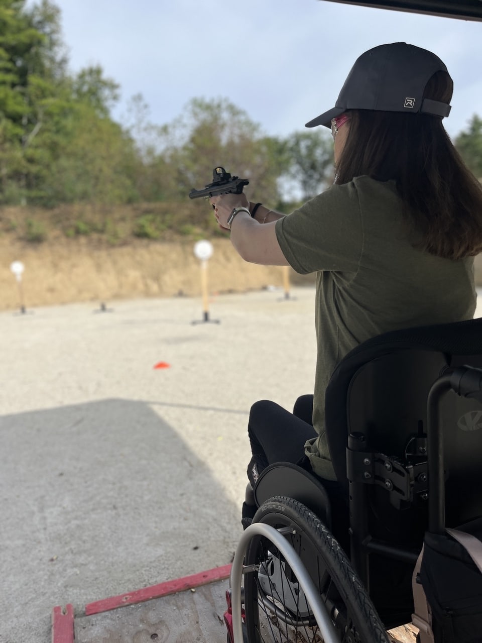 woman in wheelchair shoots on range