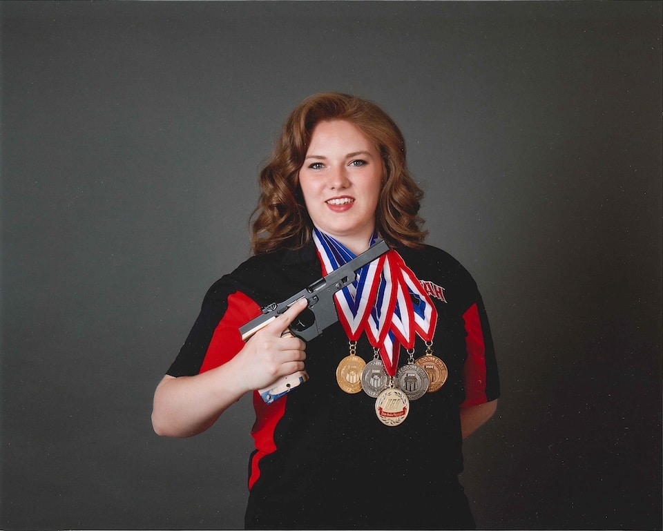Lexi Lagan with Medals and gun