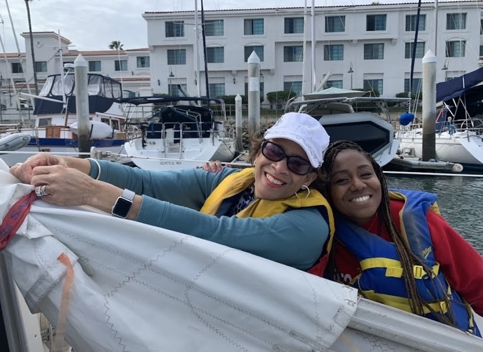 women sailing and smiling