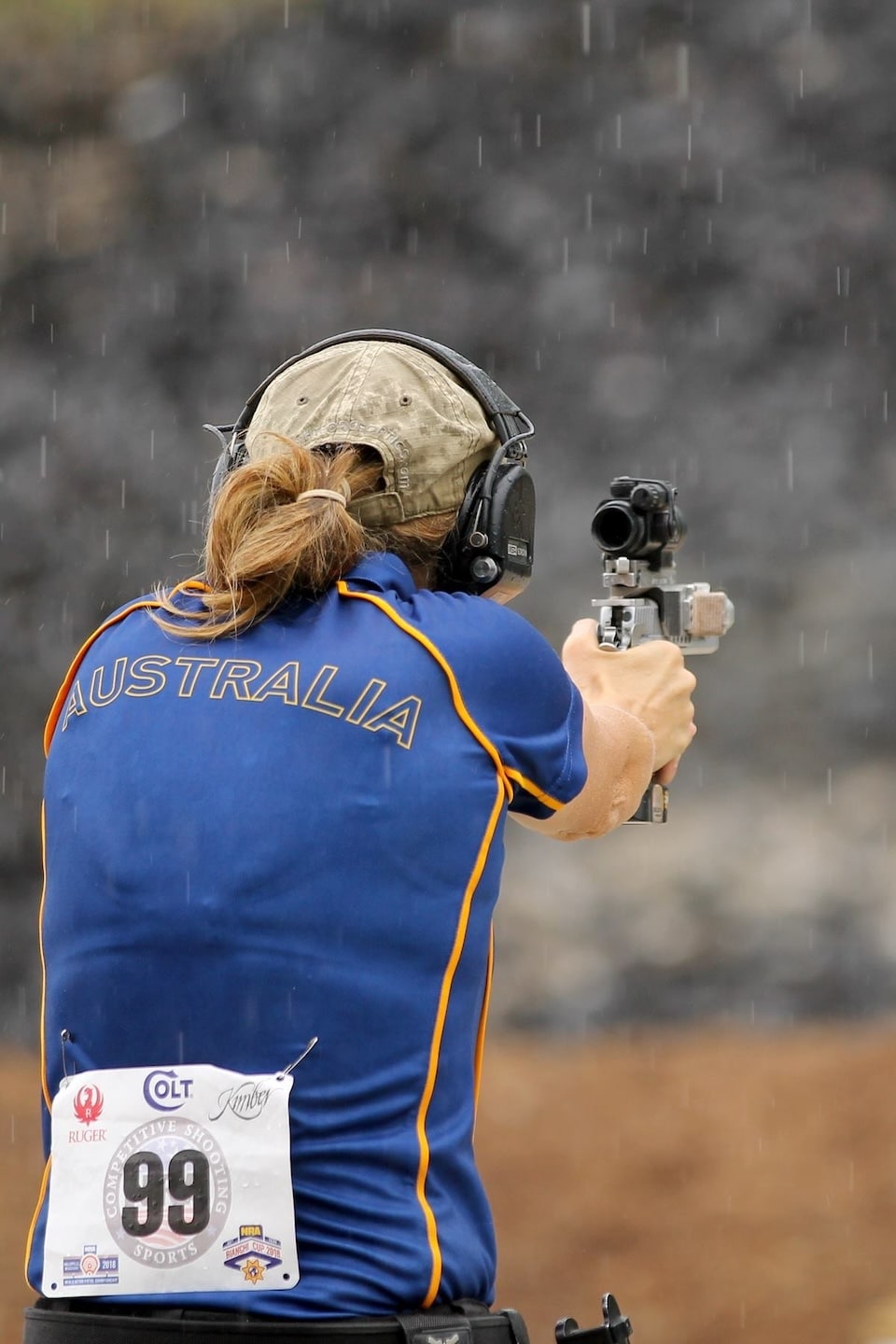 Cherie shoots in the rain at a 2018 action pistol match. (Julie Golob photo)