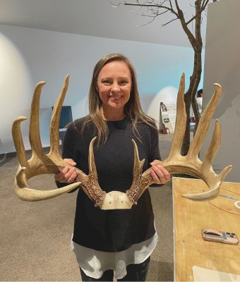 Feature photo of Amy Hall with deer rack