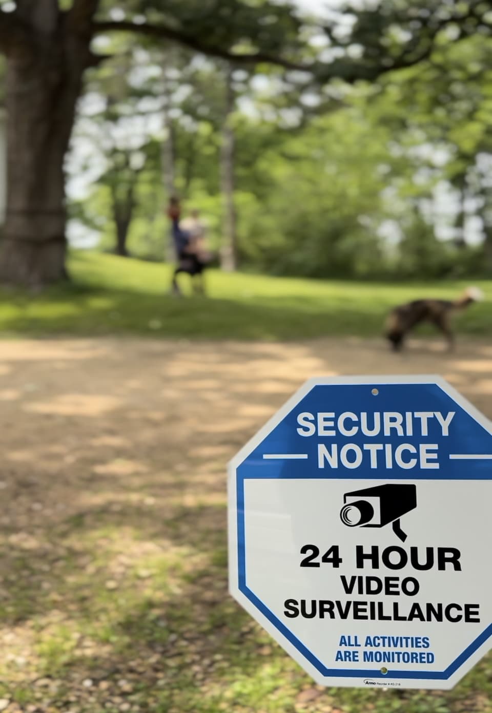 Security-sign-in-foreground-kids-and-dog-in-the-background