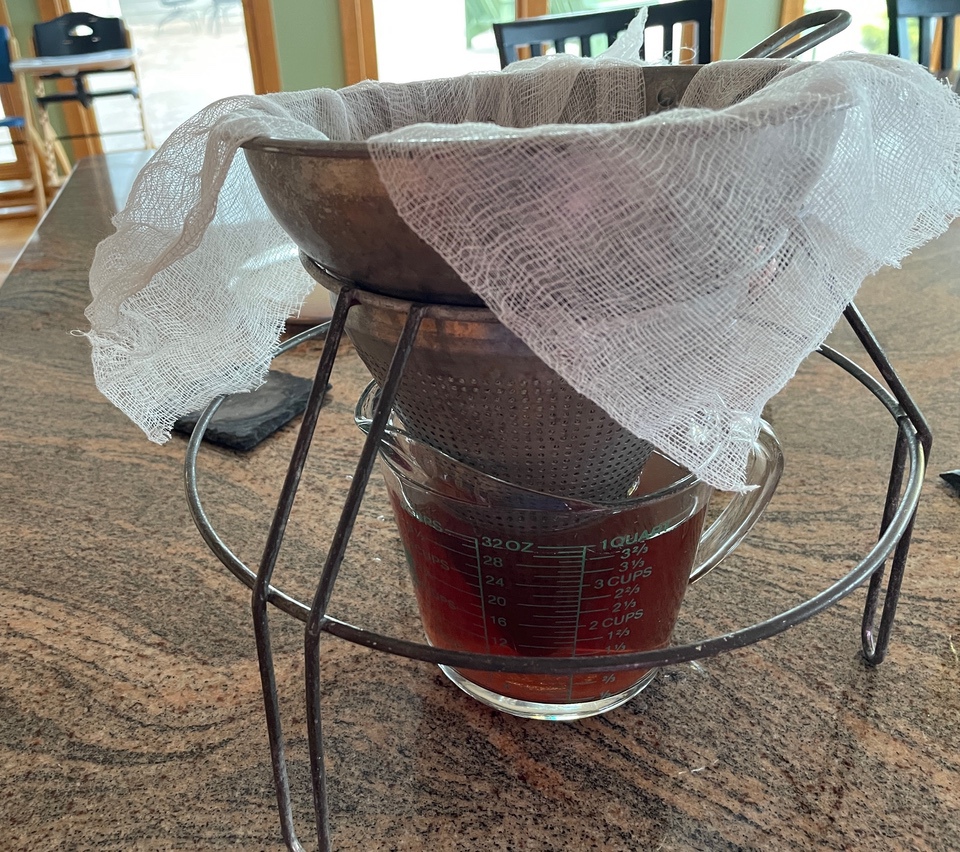 Straining redbud tea