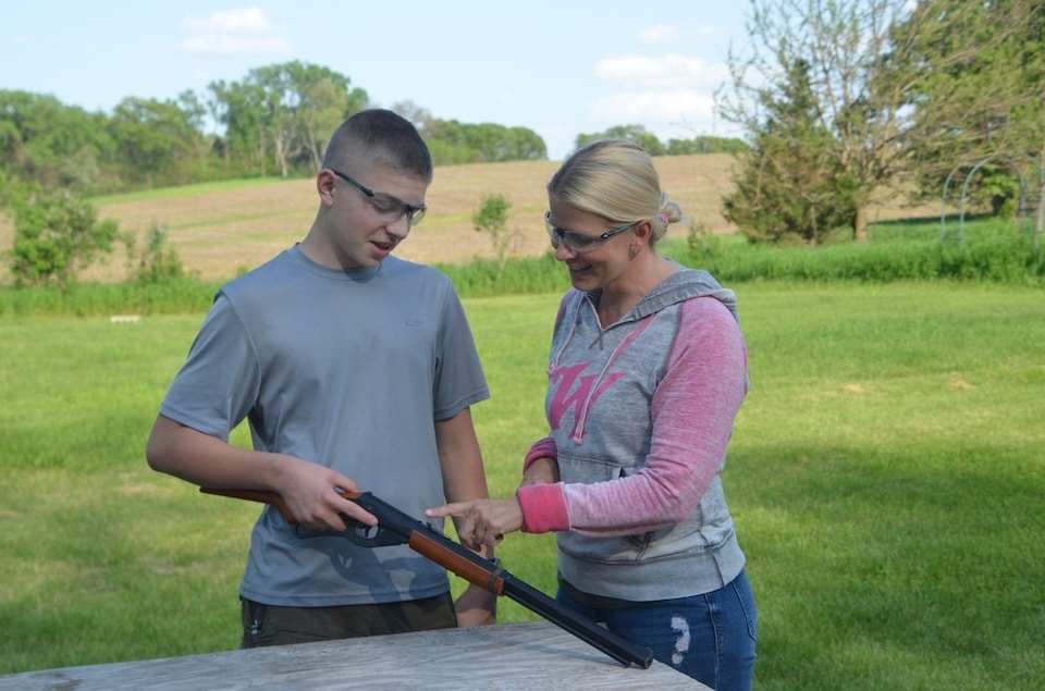mom showing son gun safety Introduce Children to Home Defense