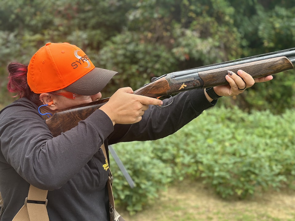 Woman shooting syren orange hat