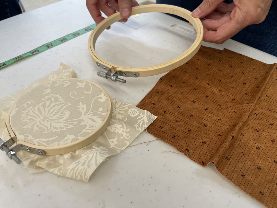 placing fabric into hoop