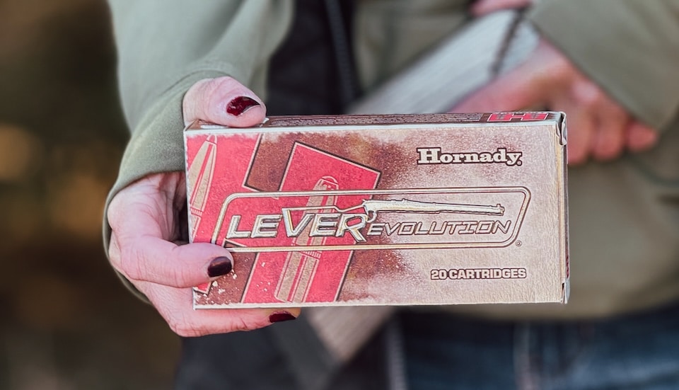 Woman holding Hornady LeveRevolution ammunition .45-70