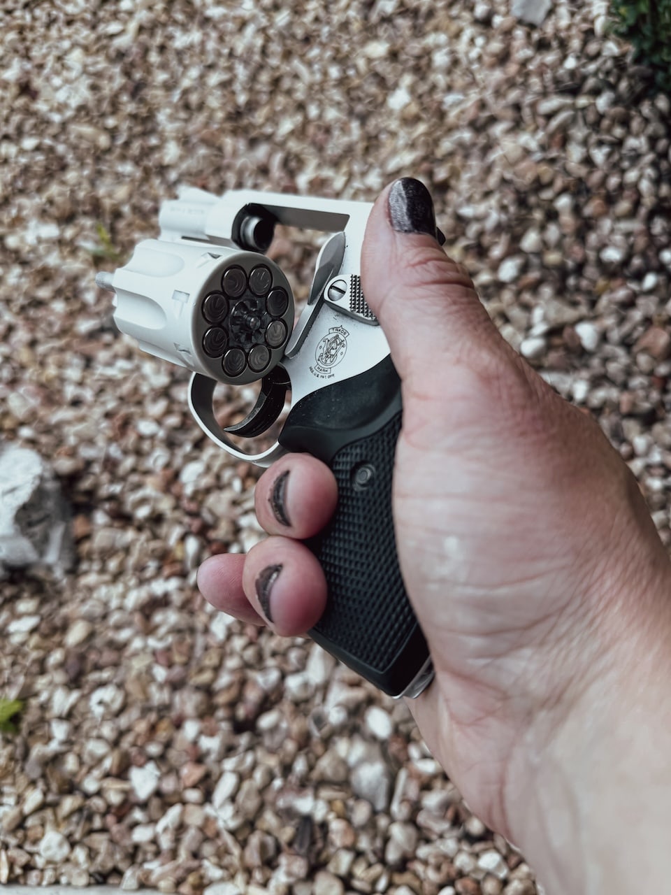 A woman's hand holding a 22 revolver with Punch ammo Concealed Carry