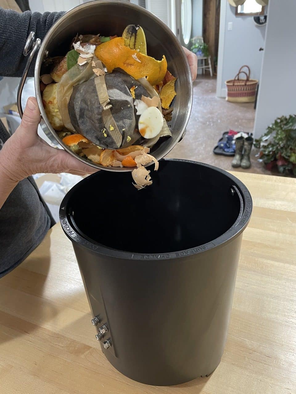 pouring into Vego Kitchen composter