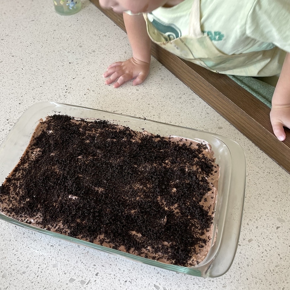 Adding cookie crumb topping to cake