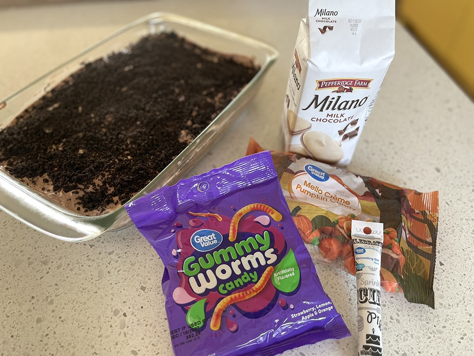Decorating the cemetery dirt and worms cake